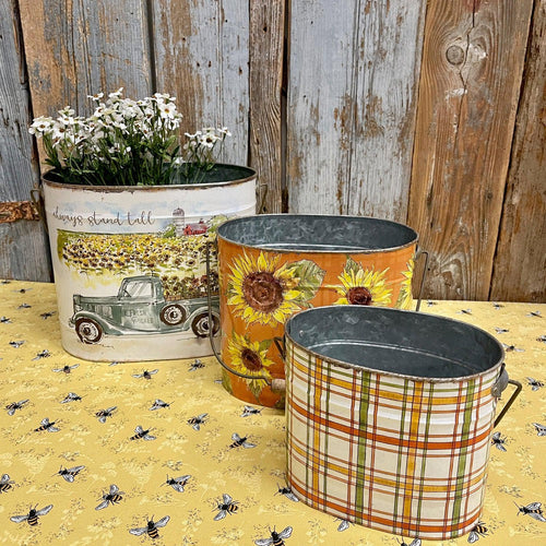 Farmhouse Buckets with a country scene, sunflowers and plaids.