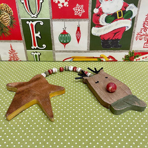 Wooden Holiday Ornament with Star and Reindeer.