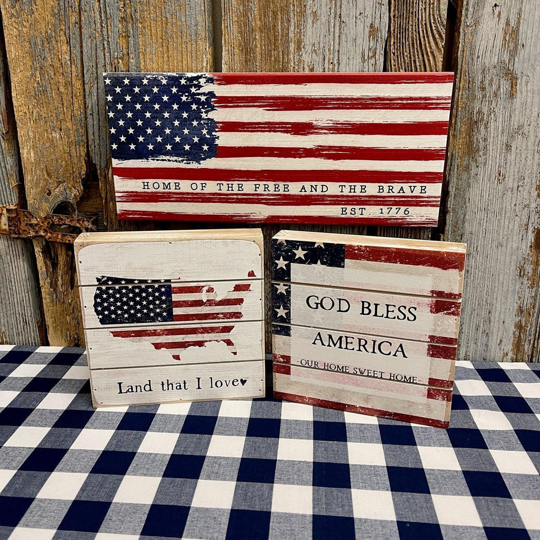 Americana Wood Signs with red and blue flag graphics.