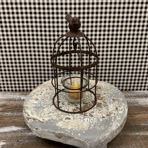 Small metal lantern with votive holder and bird accent