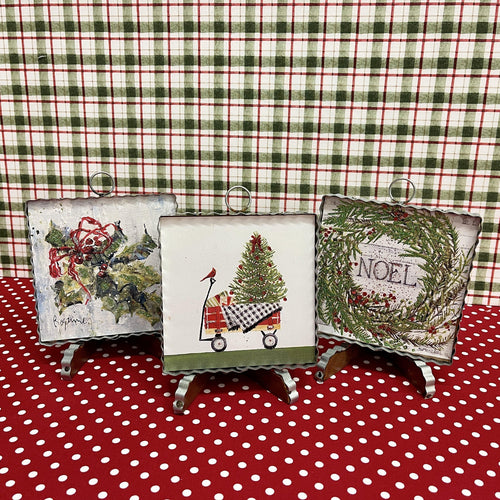 Christmas prints framed in corrugated metal.