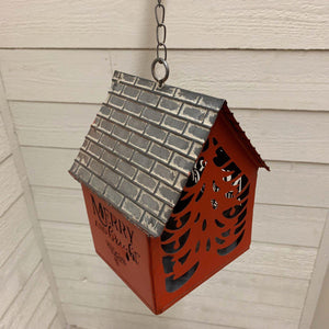 Red metal hanging house ornament with cut out lettering and tree