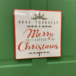 Christmas enamel sign with holiday reds and greens