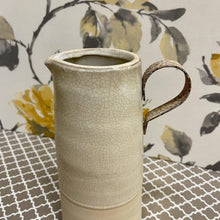 Load image into Gallery viewer, Two Tone Pottery Pitcher with a creamy crackle finish and rustic metal handle.