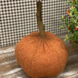 Handmade pumpkin in orange fabric with wood stem 