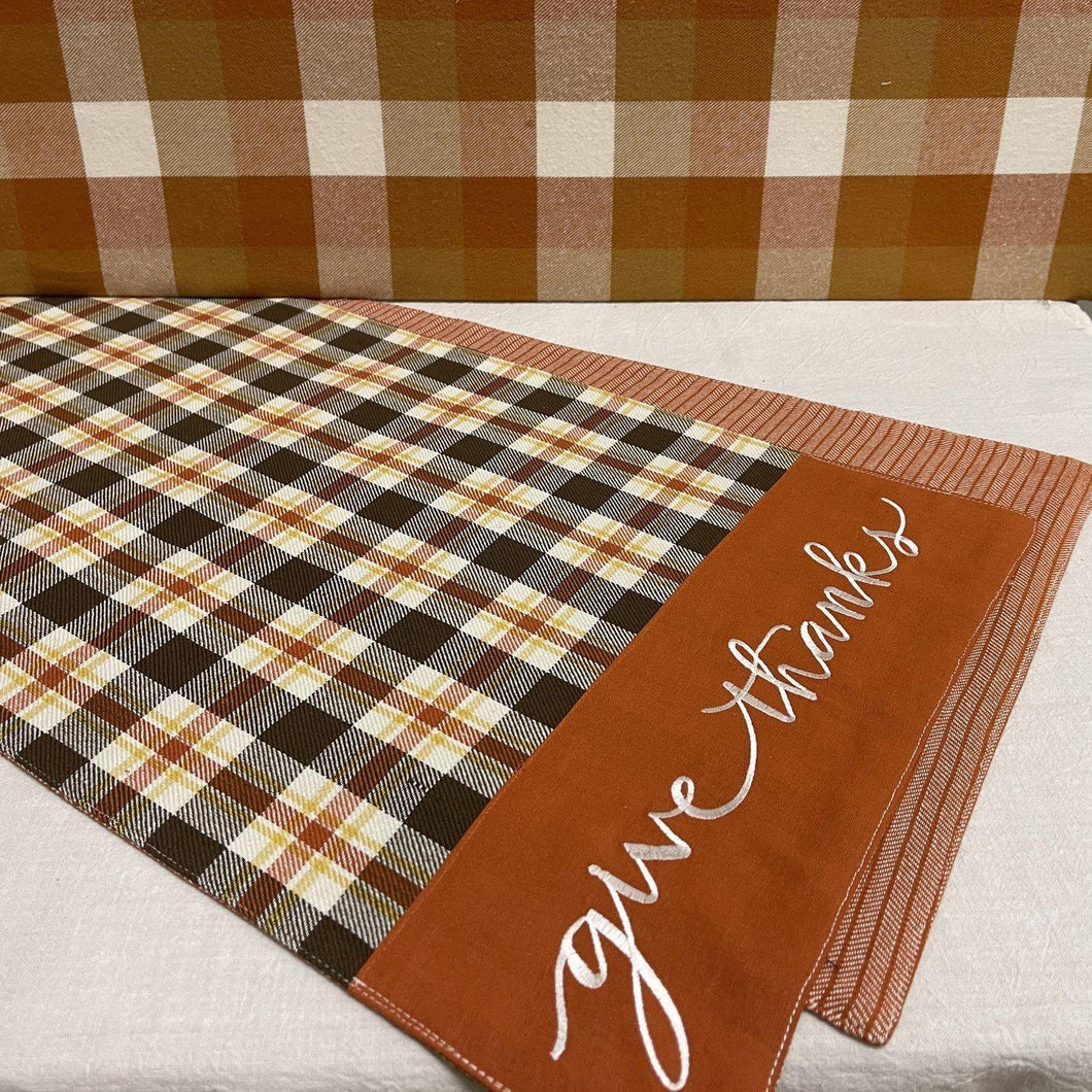 Fall table runner with seasonal colors and check designs