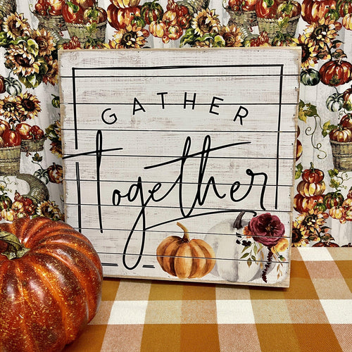 Fall wood sign with pumpkins and seasonal message 'gather together'