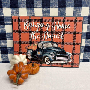 Farmhouse Fall sign with farm truck with a load of fresh picked pumpkins.