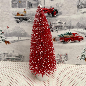 Small Red flocked Christmas Tree with snow tipped branches.