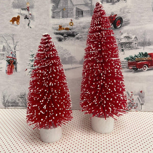 Red flocked Christmas Trees with snow tipped branches.