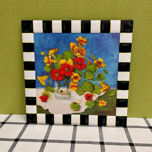 Floral Artwork painted and framed in a metal border with bright colors.