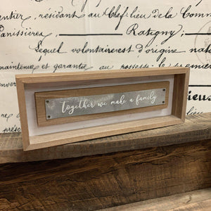 Small wood sign with white script on metal strip