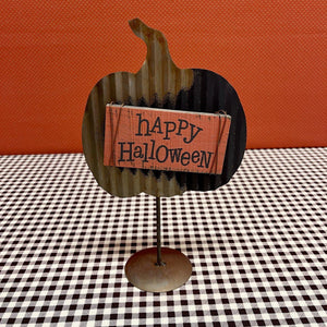 Happy Halloween sign on metal pumpkin