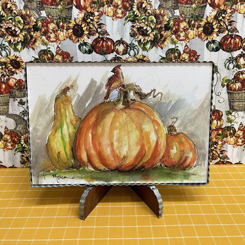 Framed art with pumpkin and cardinal framed in corrugated metal