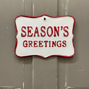 Season's Greetings metal sign in red and white