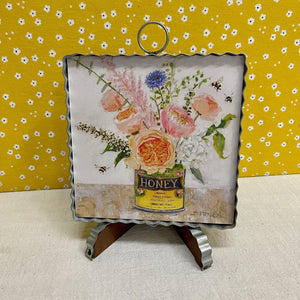 Corrugated metal Framed Spring Print with floral arrangement in a metal honey can.