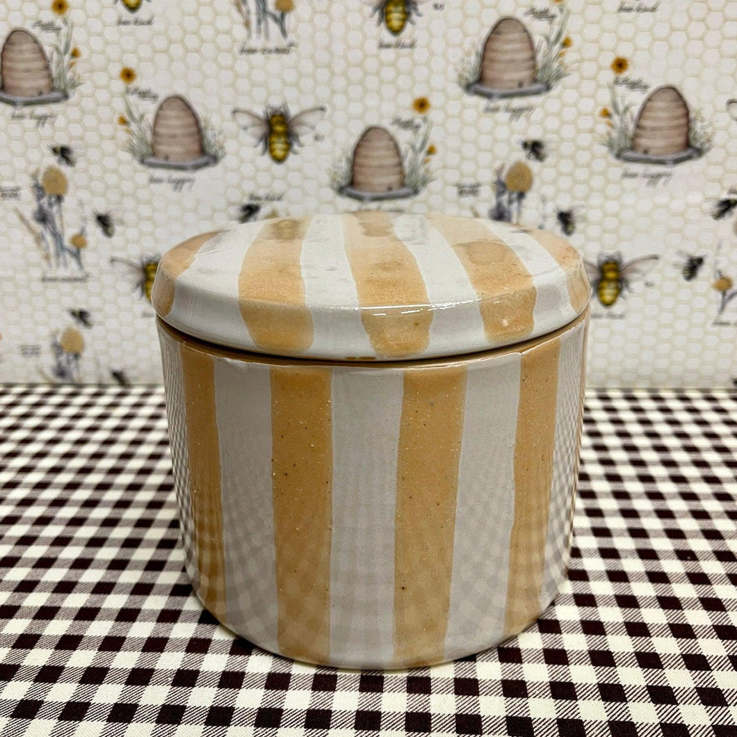 Lovely Stoneware Canister with stripes in muted colors.