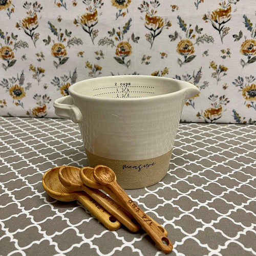 Stoneware Measuring Cup and wooden Spoons in two tone cream colors.