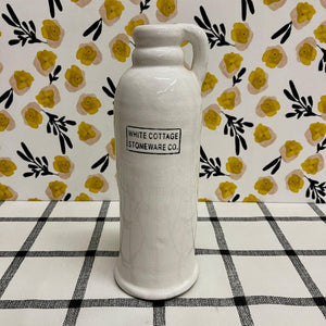 Creamy white Stoneware Vase with handle and "White Cottage Stoneware" lettering.
