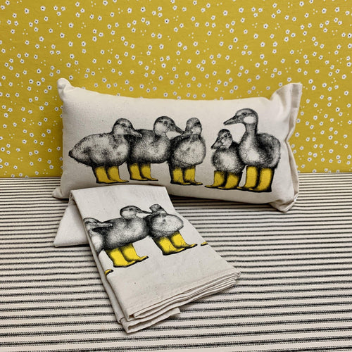Spring pillow and tea towel with ducks wearing bright yellow boots