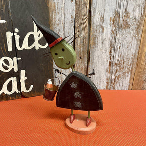 Wooden witch ready for trick or treating