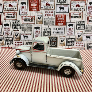 Decorative white metal farm truck with red trim