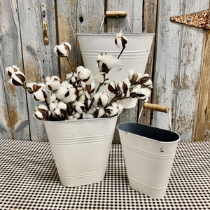 White metal buckets with cotton stems