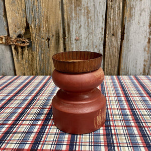 Small red candle display with tin top