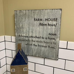 Metal farmhouse sign with cutout letters and a weathered finish