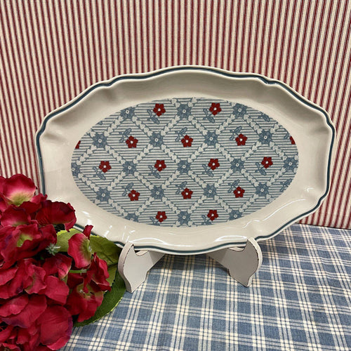 Scalloped stoneware platter in soft reds and blues